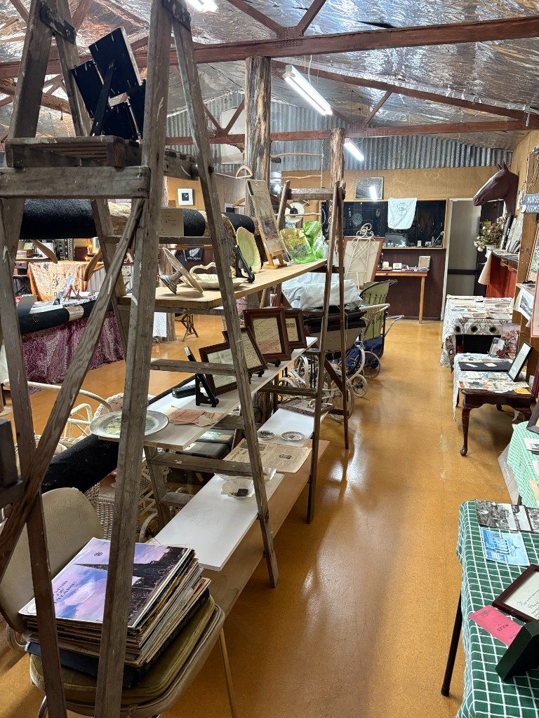 Cobb & Co print and small antiques on a display table