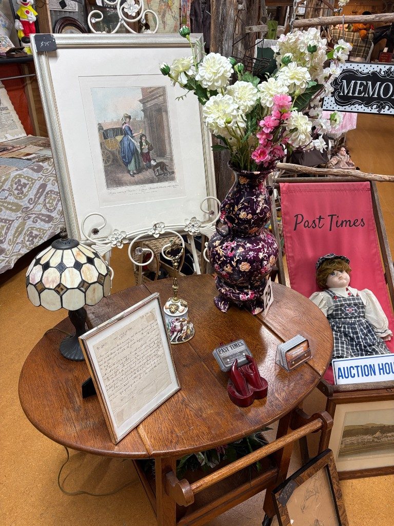 Past Times display with antiques and a branded deck chair