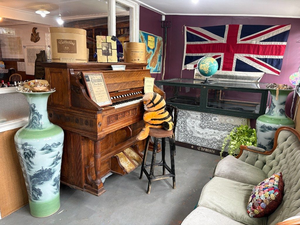 Red vintage chair, doll and historical prints